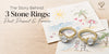 120-character version: Three stone diamond rings in yellow gold displayed on beach drawings, representing past, present, and forever.