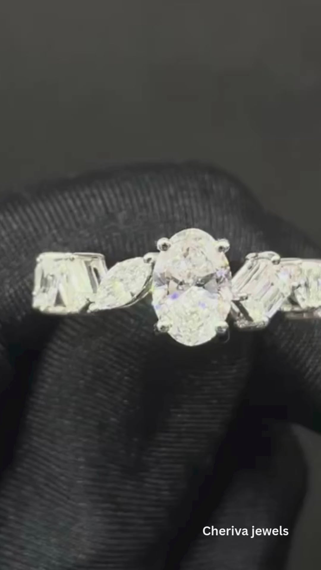 Cluster design including oval, emerald, marquise and trapezoid shape.